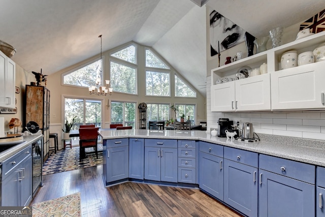 kitchen with white cabinets, dark wood-type flooring, blue cabinetry, decorative light fixtures, and a chandelier