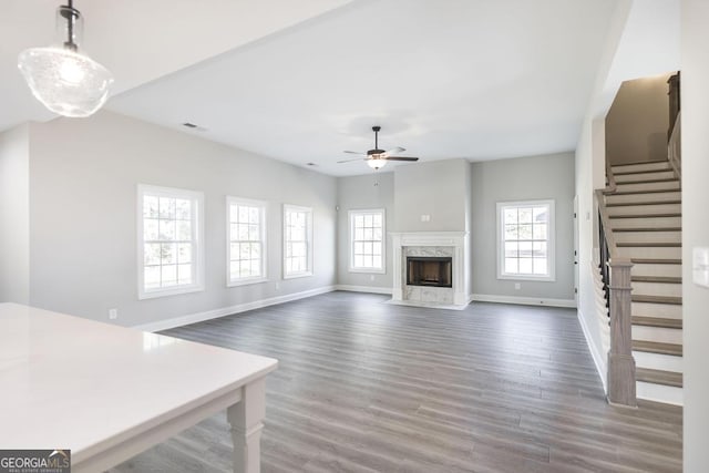 408 Bella Notte Cir Unit 26A, Warner Robins, GA 31088 - unfurnished living room with a ceiling fan, healthy amount of natural light, stairway, and wood finished floors
