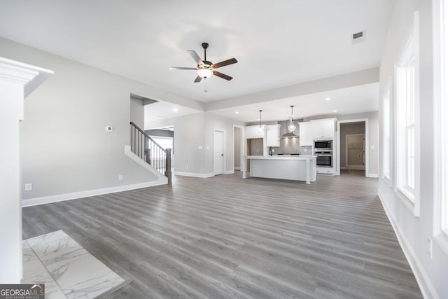 408 Bella Notte Cir Unit 26A, Warner Robins, GA 31088 - unfurnished living room with ceiling fan, recessed lighting, stairway, and wood finished floors