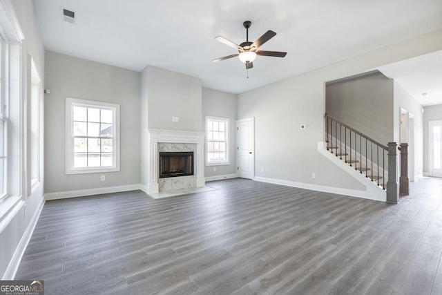 408 Bella Notte Cir Unit 26A, Warner Robins, GA 31088 - unfurnished living room featuring ceiling fan, wood finished floors, a high end fireplace, and stairs