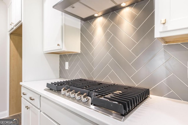 408 Bella Notte Cir Unit 26A, Warner Robins, GA 31088 - kitchen view of wall chimney range hood, stainless steel gas stovetop, white cabinetry, light countertops, and tasteful backsplash