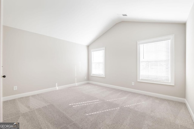 408 Bella Notte Cir Unit 26A, Warner Robins, GA 31088 - spare room featuring carpet and lofted ceiling