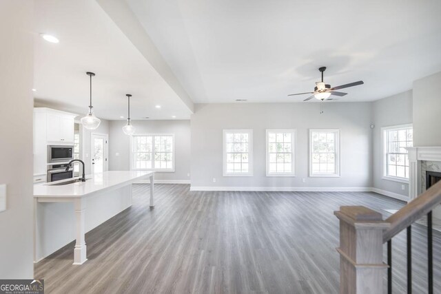 408 Bella Notte Cir Unit 26A, Warner Robins, GA 31088 - unfurnished living room with a ceiling fan, wood finished floors, recessed lighting, and a fireplace