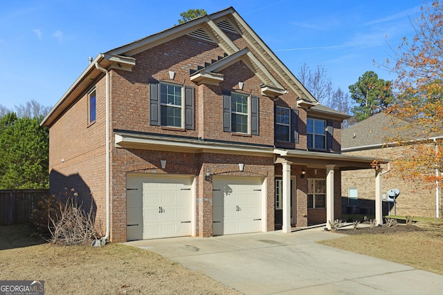 view of front of house with a garage, driveway, and brick siding