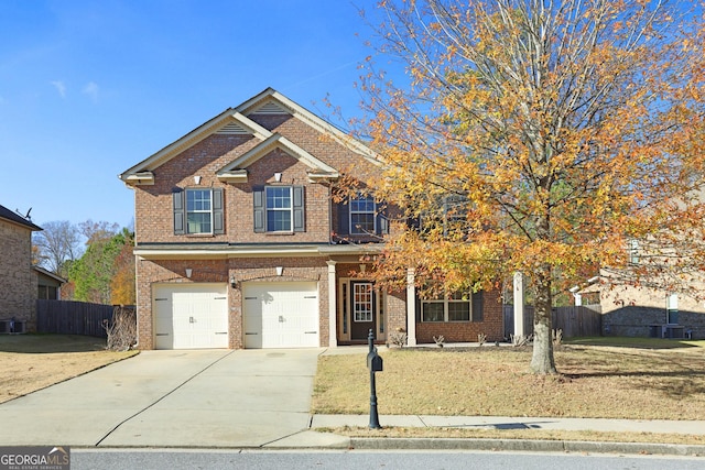 view of front of property with fence, concrete driveway, and brick siding