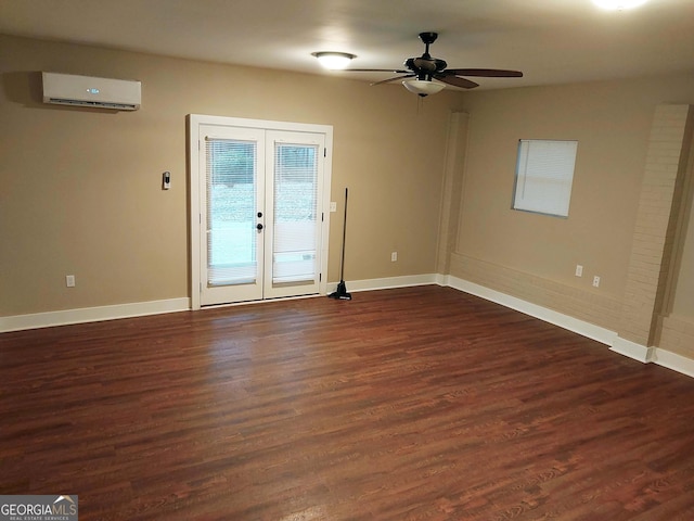 empty room with french doors, dark wood finished floors, baseboards, a wall mounted air conditioner, and ceiling fan