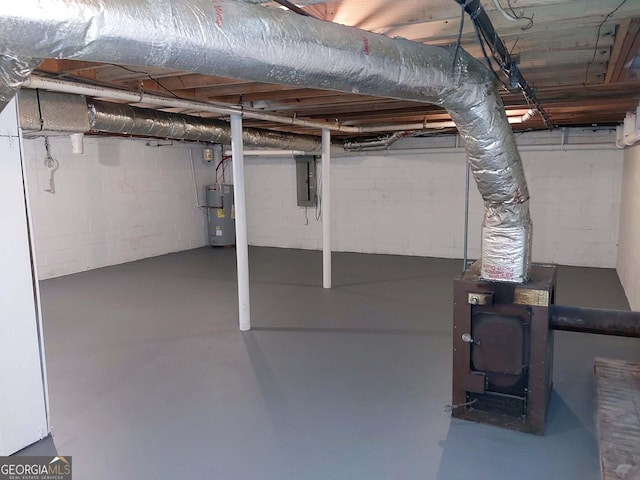 unfinished basement featuring electric panel and electric water heater