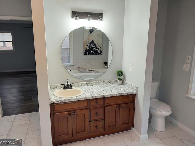 bathroom with baseboards, marble finish floor, vanity, and toilet