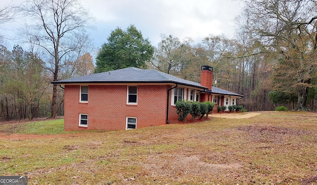 view of side of home featuring a yard