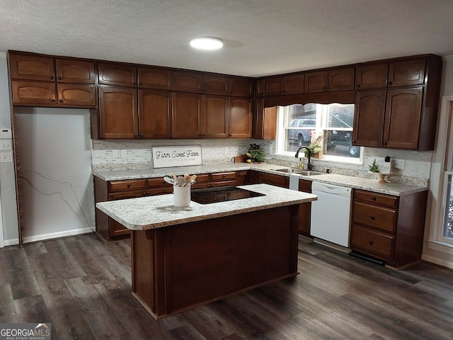 kitchen featuring dark wood-style floors, dishwasher, a sink, decorative backsplash, and black electric stovetop