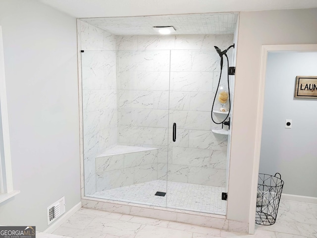 full bathroom featuring a shower stall, marble finish floor, baseboards, and visible vents