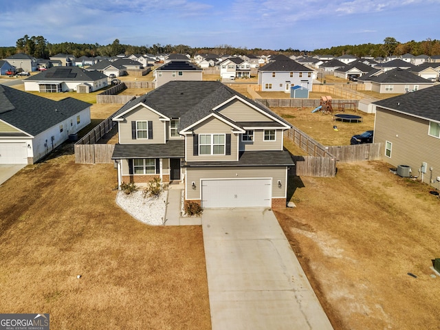 299 Archibald Ave SE, Ludowici, GA 31316 - traditional-style home with a residential view, a shingled roof, concrete driveway, central AC unit, and brick siding