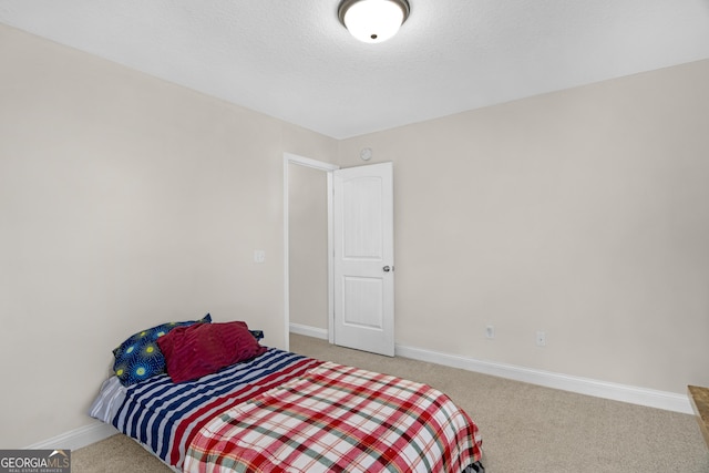 carpeted bedroom featuring a textured ceiling