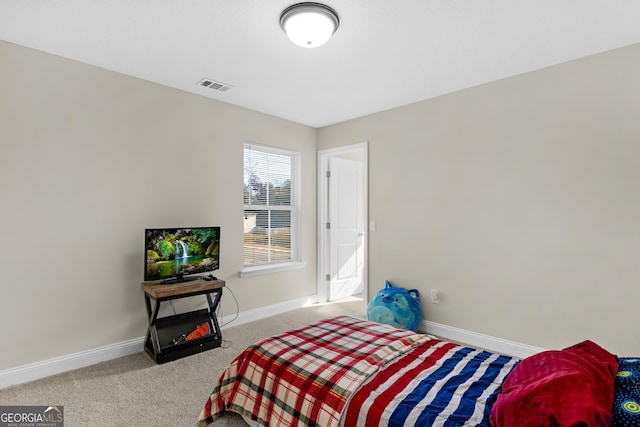 bedroom with light colored carpet