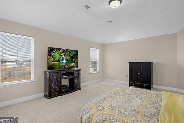 carpeted bedroom featuring lofted ceiling