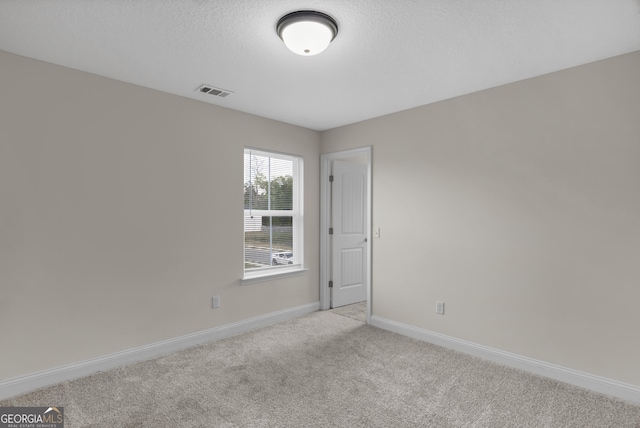 299 Archibald Ave SE, Ludowici, GA 31316 - empty room featuring visible vents, baseboards, and light carpet