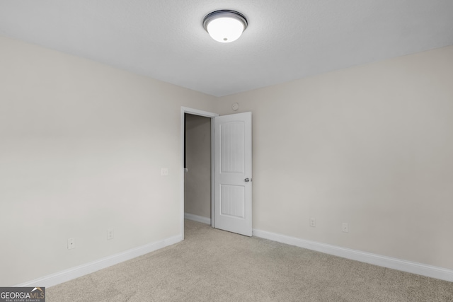 299 Archibald Ave SE, Ludowici, GA 31316 - empty room with baseboards and carpet flooring