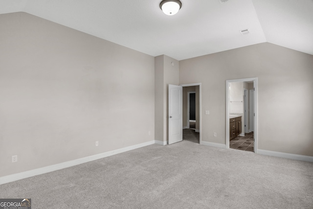 299 Archibald Ave SE, Ludowici, GA 31316 - unfurnished bedroom with lofted ceiling, baseboards, visible vents, and carpet floors