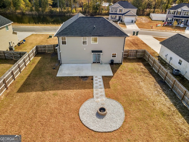 back of house with a patio area and a yard