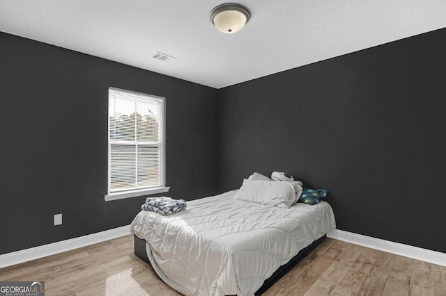 bedroom with light hardwood / wood-style flooring