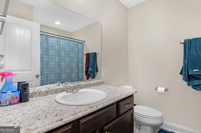 299 Archibald Ave SE, Ludowici, GA 31316 - bathroom featuring toilet, a shower with shower curtain, baseboards, and vanity