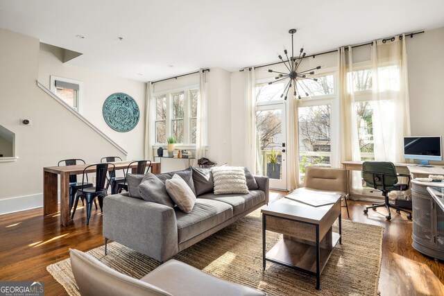 living room with a chandelier and dark hardwood / wood-style floors