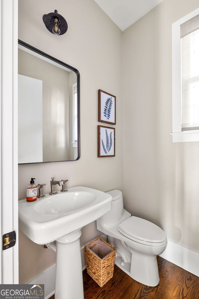 bathroom with hardwood / wood-style floors and toilet