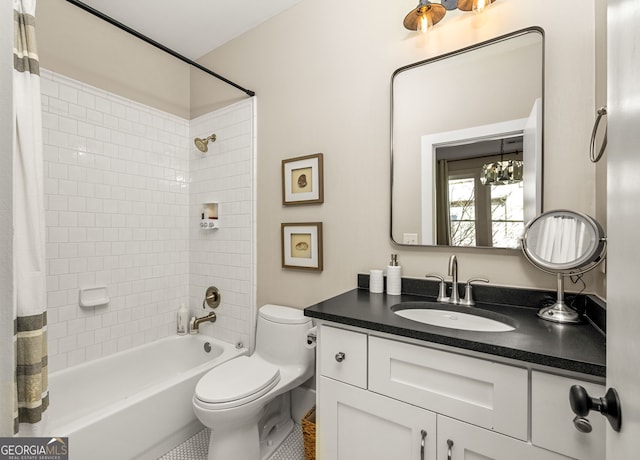 full bathroom featuring a chandelier, vanity, shower / bath combination with curtain, and toilet