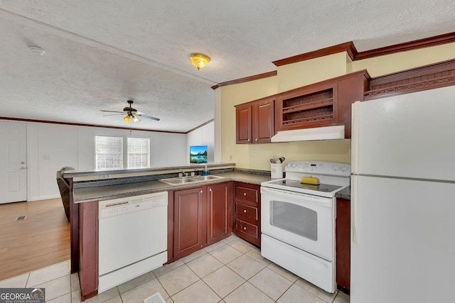 kitchen with a textured ceiling, kitchen peninsula, crown molding, and white appliances