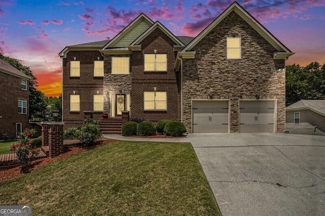 view of front of property featuring a garage and a lawn