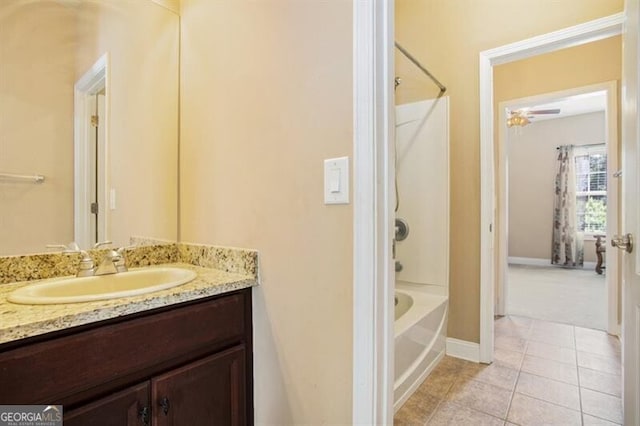 bathroom with tile patterned flooring, vanity, and shower / bathtub combination