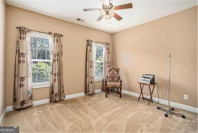 unfurnished room with light carpet and ceiling fan