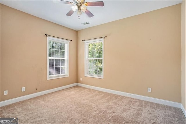 unfurnished room featuring ceiling fan and light colored carpet