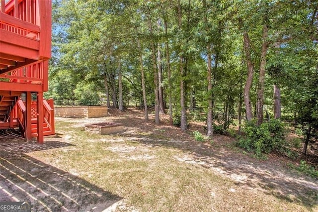 view of yard featuring a wooden deck