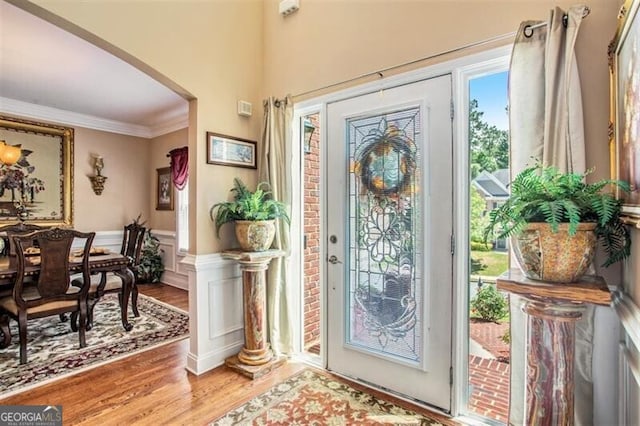 entrance foyer featuring hardwood / wood-style flooring and crown molding