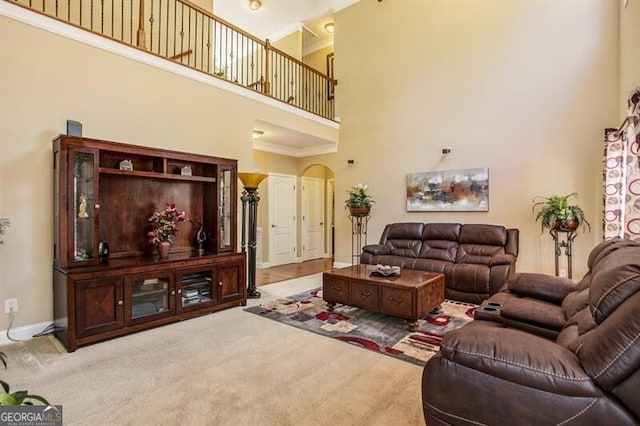 living room featuring light colored carpet and a high ceiling