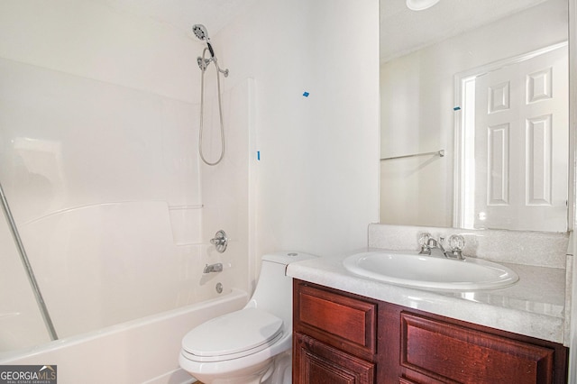 bathroom with shower / washtub combination, vanity, and toilet