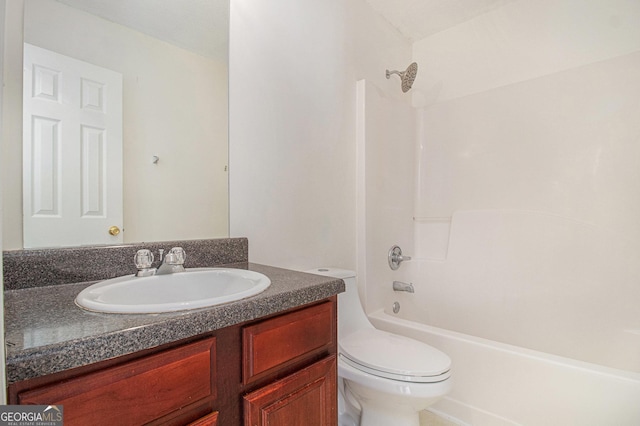 bathroom featuring tub / shower combination, vanity, and toilet