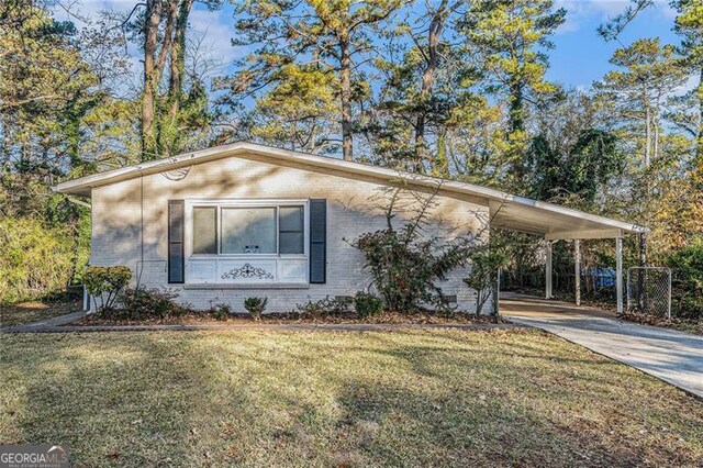 view of front of property with a front lawn and a carport