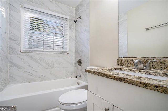 full bathroom with vanity, toilet, and tiled shower / bath