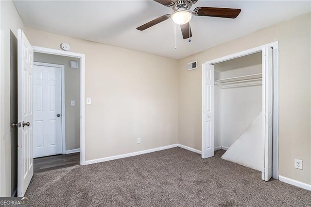 unfurnished bedroom featuring dark colored carpet, ceiling fan, and a closet