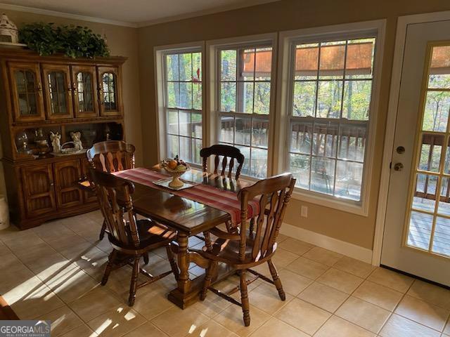 dining room featuring ornamental molding and light tile patterned floors