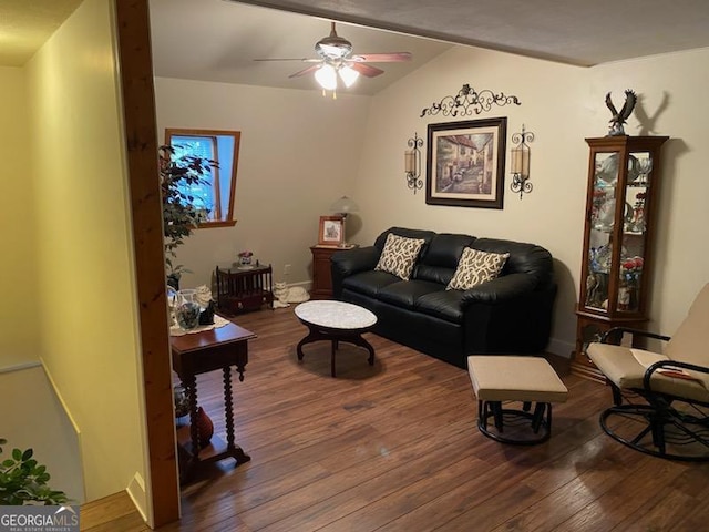 living room featuring ceiling fan, dark hardwood / wood-style flooring, and vaulted ceiling