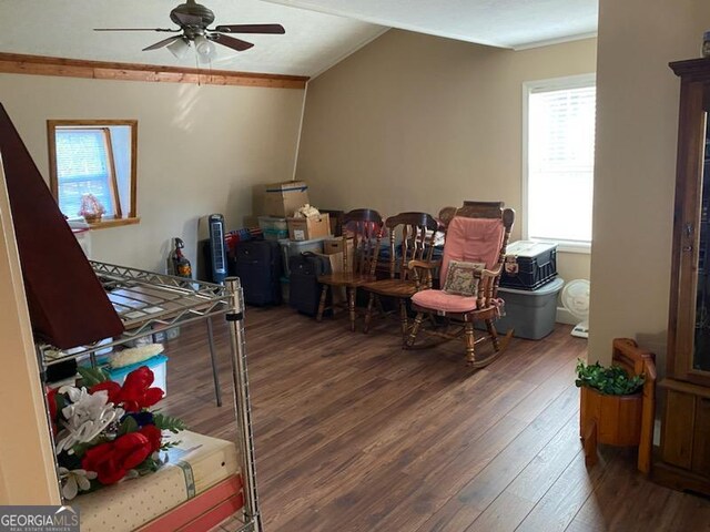 interior space featuring ceiling fan, ornamental molding, and dark hardwood / wood-style flooring