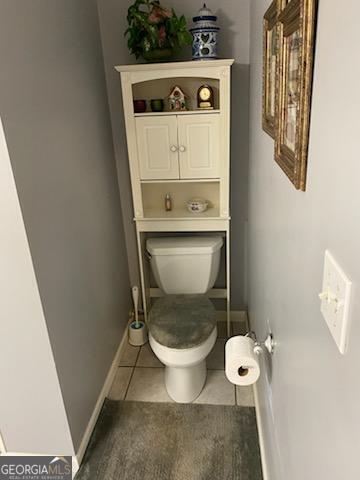 bathroom featuring tile patterned flooring and toilet