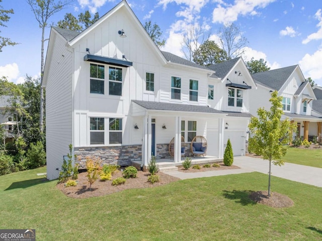 modern inspired farmhouse with a garage, covered porch, and a front yard