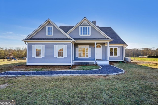 view of front of house featuring covered porch, a front lawn, and cooling unit