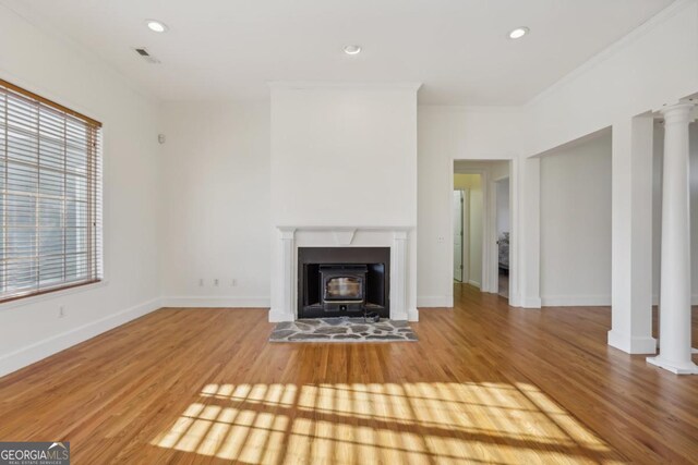 kitchen with white cabinets, light hardwood / wood-style floors, and crown molding