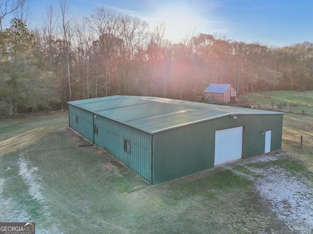 view of outbuilding featuring a garage and a lawn