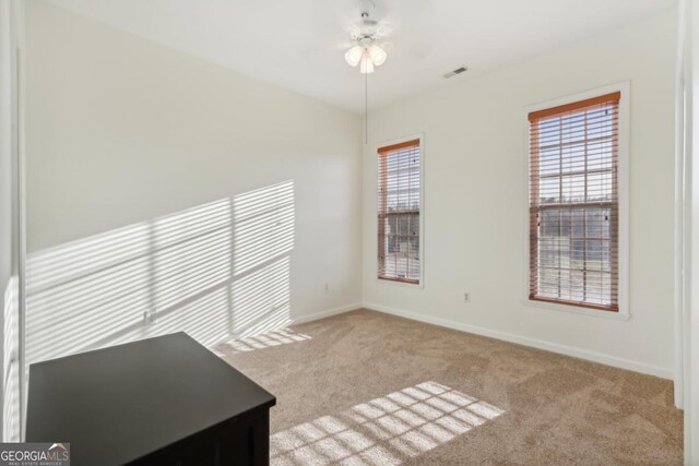 unfurnished bedroom with light carpet, a closet, and ceiling fan